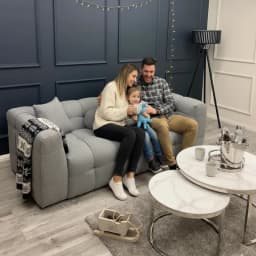 family sitting on a bubble sofa in living room