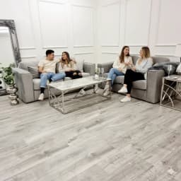 people sitting on a cushion sofa set