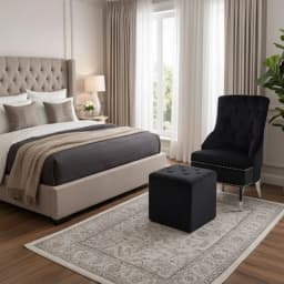 a bedroom with a comfort chair and stool