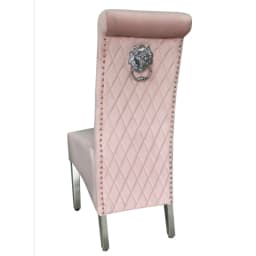 Pink dining chair with a silver lion knocker behind