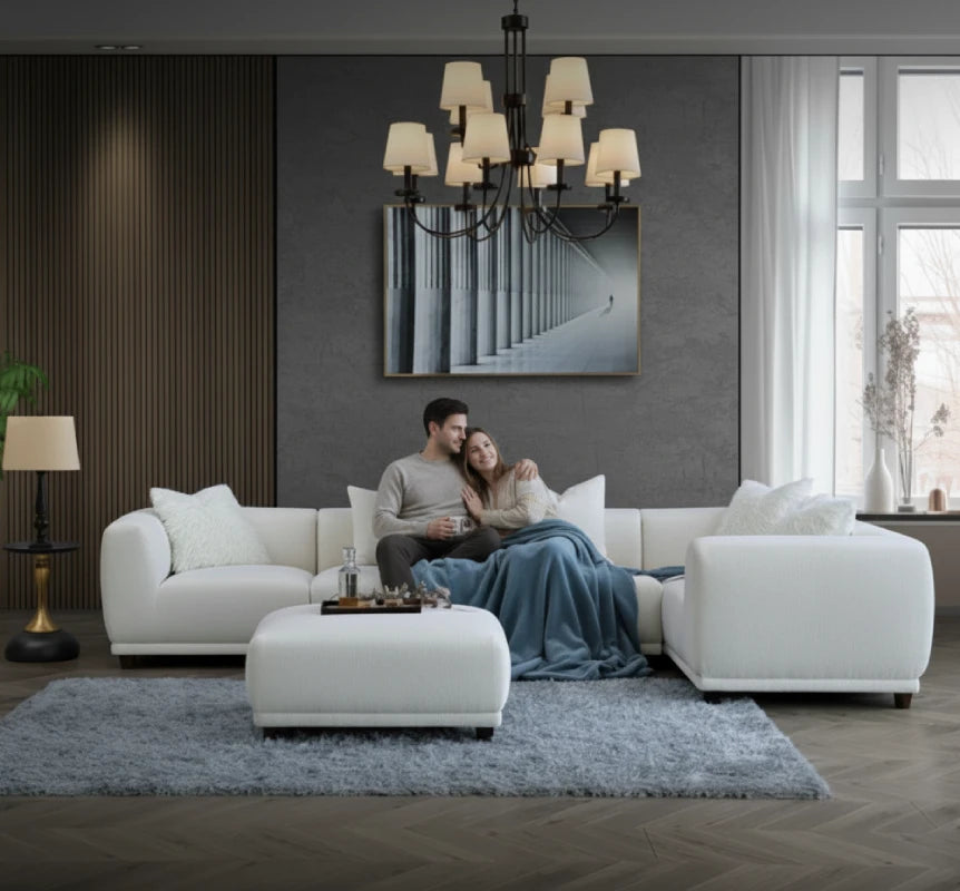 white white corner sofa with footstool and a couple sitting it