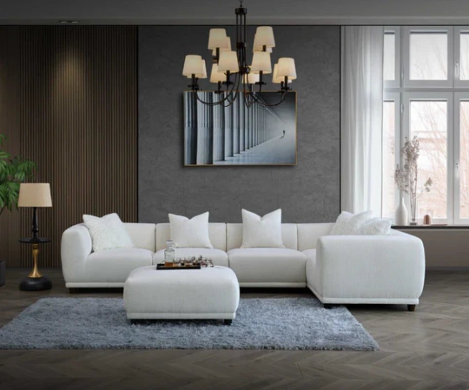 white corner sofa with footstool in the centre