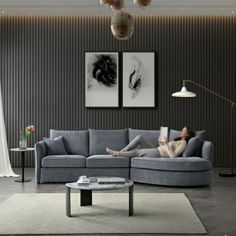 A lady lying on a chaise sofa and reading