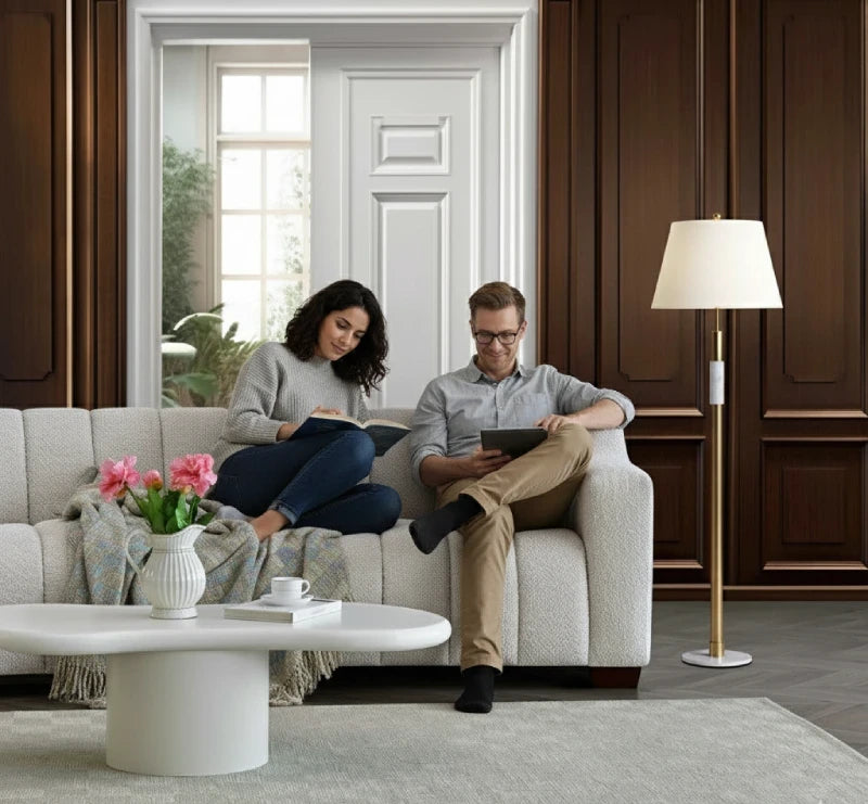 A couple reading while seating on a sofa