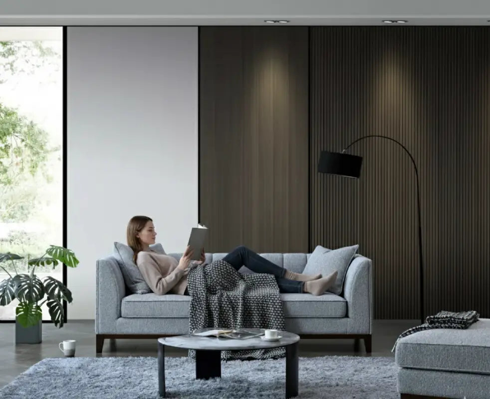 picture of a lady lying on a boucle sofa and reading