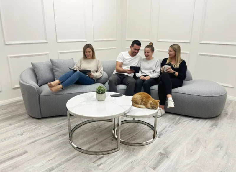people in a living room sitting on a cinema-style sofa