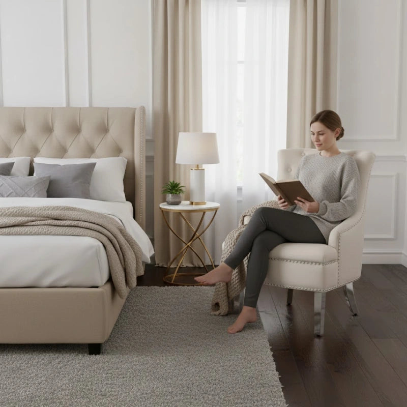a woman sitting on her wingback bedroom chair while reading