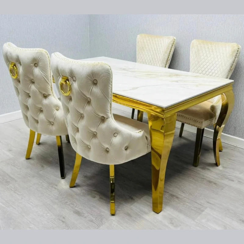 A picture of marble dining table with gold legs and chairs