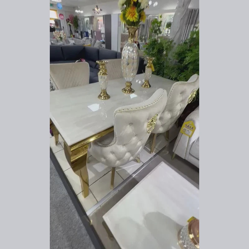 A picture of a marble dining table with gold legs